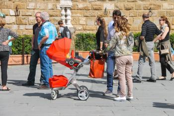 FLORENCE, ITALY - MAY 08, 2014: Young family walking in a summer town. Florence, Italy 