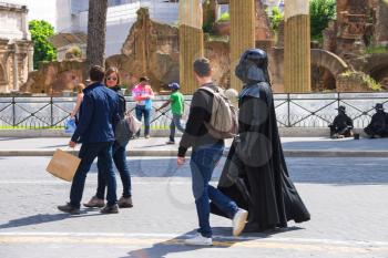 ROME, ITALY - MAY 04, 2014: Actor in costume Darth Vader walking down the street and attracted the attention of passers  in Rome, Italy