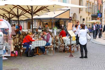 VERONA, ITALY - MAY 7, 2014: People are resting in outdoor cafe at the center Verona, Italy