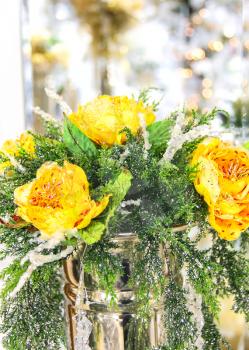 Christmas bouquet of yellow roses in a metal vase