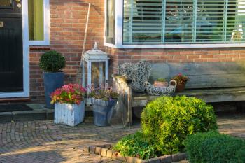 Picturesque decorative plants before residential house in small Dutch town Zwanenburg, the Netherlands