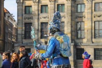 Amsterdam, the Netherlands -October 03, 2015: Human statue street performer on Dam Square in historic city centre