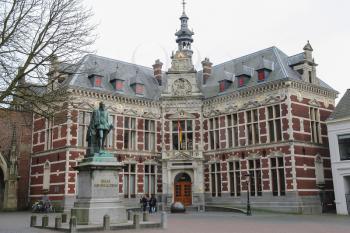 Utrecht, the Netherlands - February 13, 2016: University Hall of Utrecht University and statue of Count (Graaf) Jan van Nassau in Dom Square