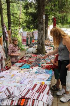 Schodnica, Ukraine - June 30, 2014: People near trade stalls with ukrainian souvenirs