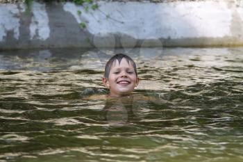 Smiling boy swimming in lake