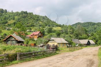 Rural houses on slope of forested mountains. Carpathians, Ukraine