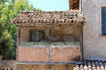 Part of old building with balcony in medieval castle. Grazzano Visconti, Italy
