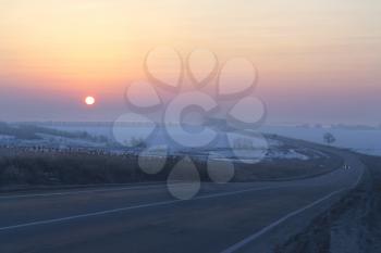 Royalty Free Photo of a Sunrise Over a Road