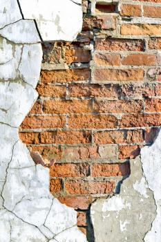 Royalty Free Photo of an Old Brick Wall With Cracked Plaster