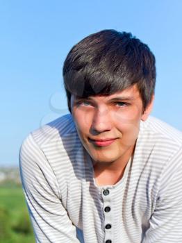 Outdoor portrait of young handsome man. Sunny evening weather.