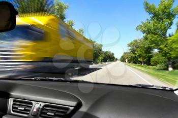 Blurred on the speed of the movement of trucks on the road from the window of an oncoming car