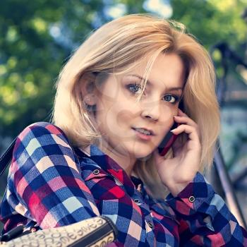 young blond girl talking on the phone
