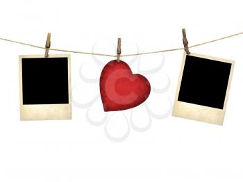 Old style photo and Valentine card heart shaped from old red paperr hanging on a clothesline isolated on white