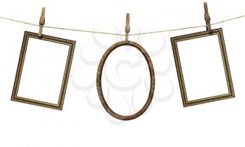 three picture frame hanging on clothespins isolated on white background