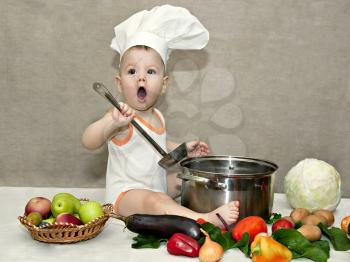 little baby in a chef's hat and ladle in hand
