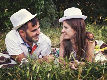 happy young couple relaxing in the park on the grass