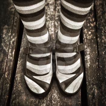 black and white Female legs in striped socks in vintage style