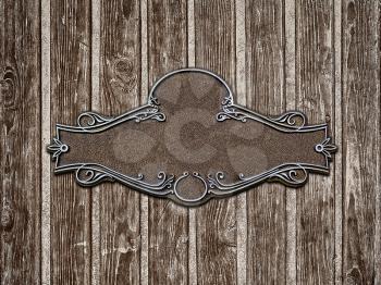 Vintage cast metal plate on old wooden texture close-up