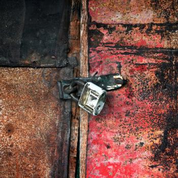 Old vintage padlock on the door of the barn