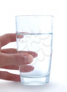 Glass of clean water in hand isolated on a white background