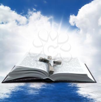 Prayer Holy book on the background of clouds and sun