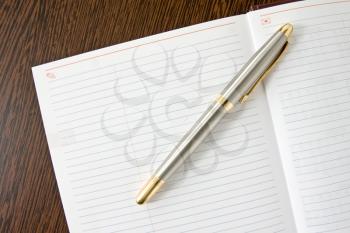 Royalty Free Photo of a Pen on a Notebook