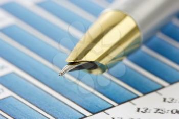 Royalty Free Photo of a Pen on Financial Graphs