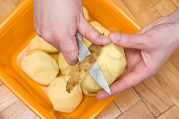 Royalty Free Photo of a Person Peeling Potatoes
