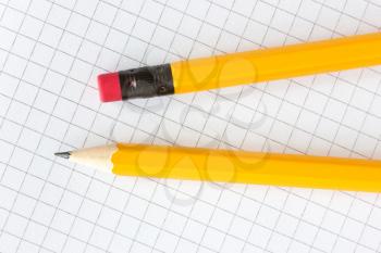 Two yellow pencils on the squared paper