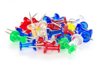 Pile of colorful pushpins on a white background