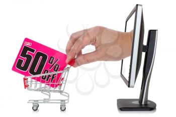Internet sale concept. Hand reaches out of a computer monitor with a shopping cart 