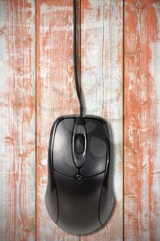 Royalty Free Photo of a Computer Mouse on Wooden Board
