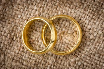 Two golden  rings on the burlap background
