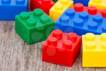 Color plastic  blocks on the wooden background
