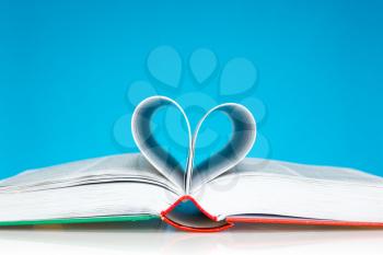 Selective focus image of book folded into a heart shape 