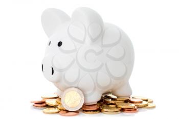 Piggy bank and coins pile on white background