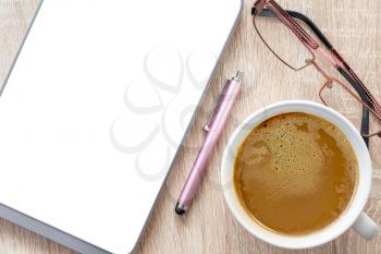 Coffee cup, glasses and tablet pc with blank screen