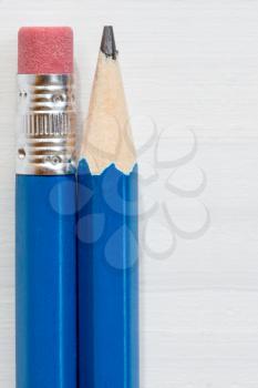 Two pencils on wooden background with copy space