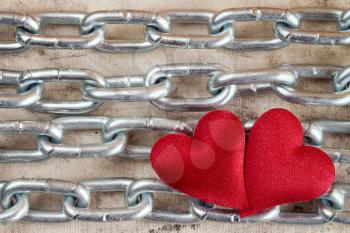 Metal chain with two hearts as a symbol of strong love