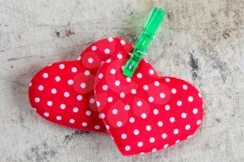 Red fabric Valentine hearts with green clothespin 