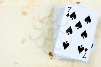 A poker card deck with seven of spades on the top