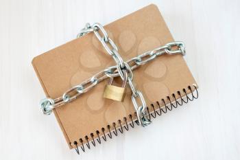 Censorship  concept, notepad with chain and padlock