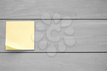 Wooden wall with  blank sticky note for your text