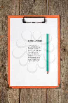 Clipboard with pencil and  list of resolutions for new year