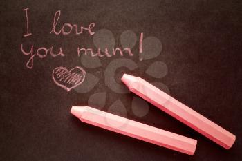 Text i love you mum written with chalk in old board 