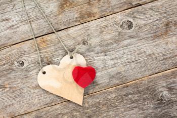 Valentine concept. Love hearts  hanging on wooden background.