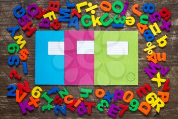 Three exercise books and border of colorful letters and numbers
