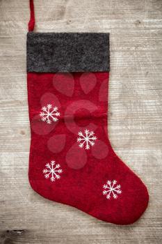 Festive christmas stocking hanging on a wooden background