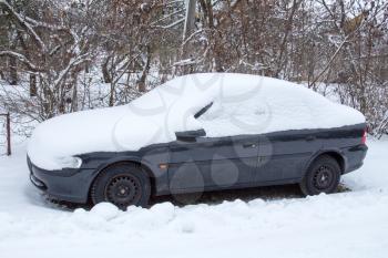 Car covered with snow in a cold weather
