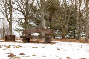 Empty wooden bench in a park at winter time